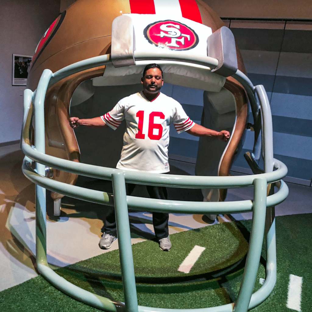 Vivek Sukumaran posing inside large football helmet