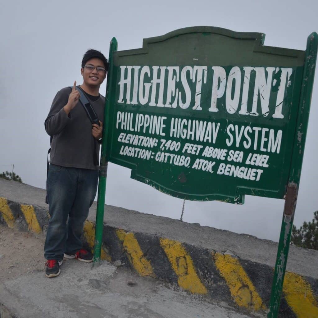 Kristian Divina posing at the highest point of the Philippine highway system