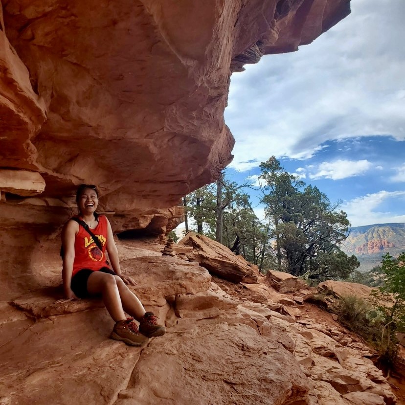 Karina Biacan sitting on a large rock