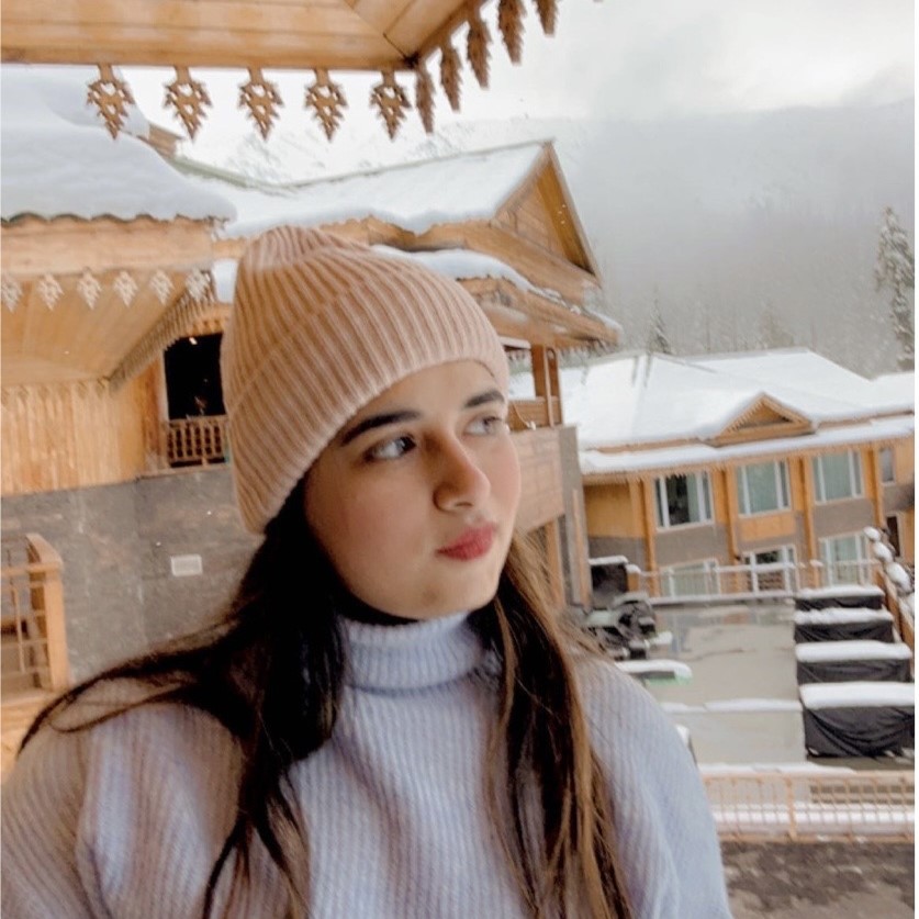 Riya Rajdev in a log cabin