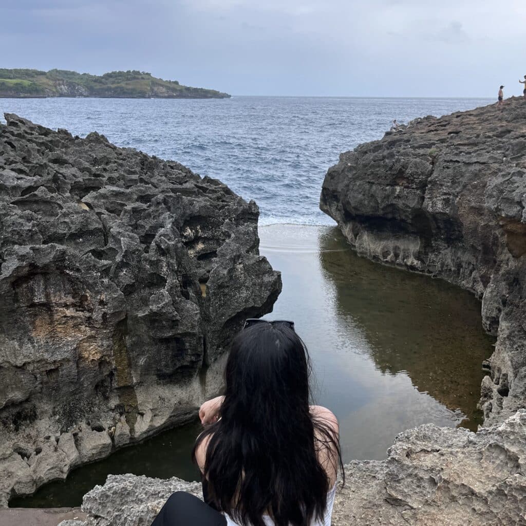 Ella Hu looking over a river