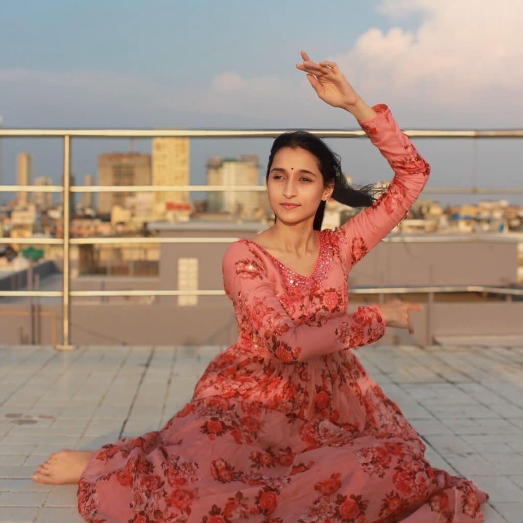 alisha bhandari in a dress on a rooftop