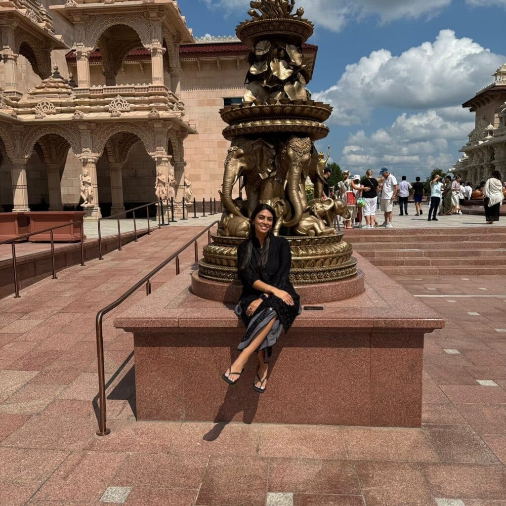 yesha nar in front of a sculpture